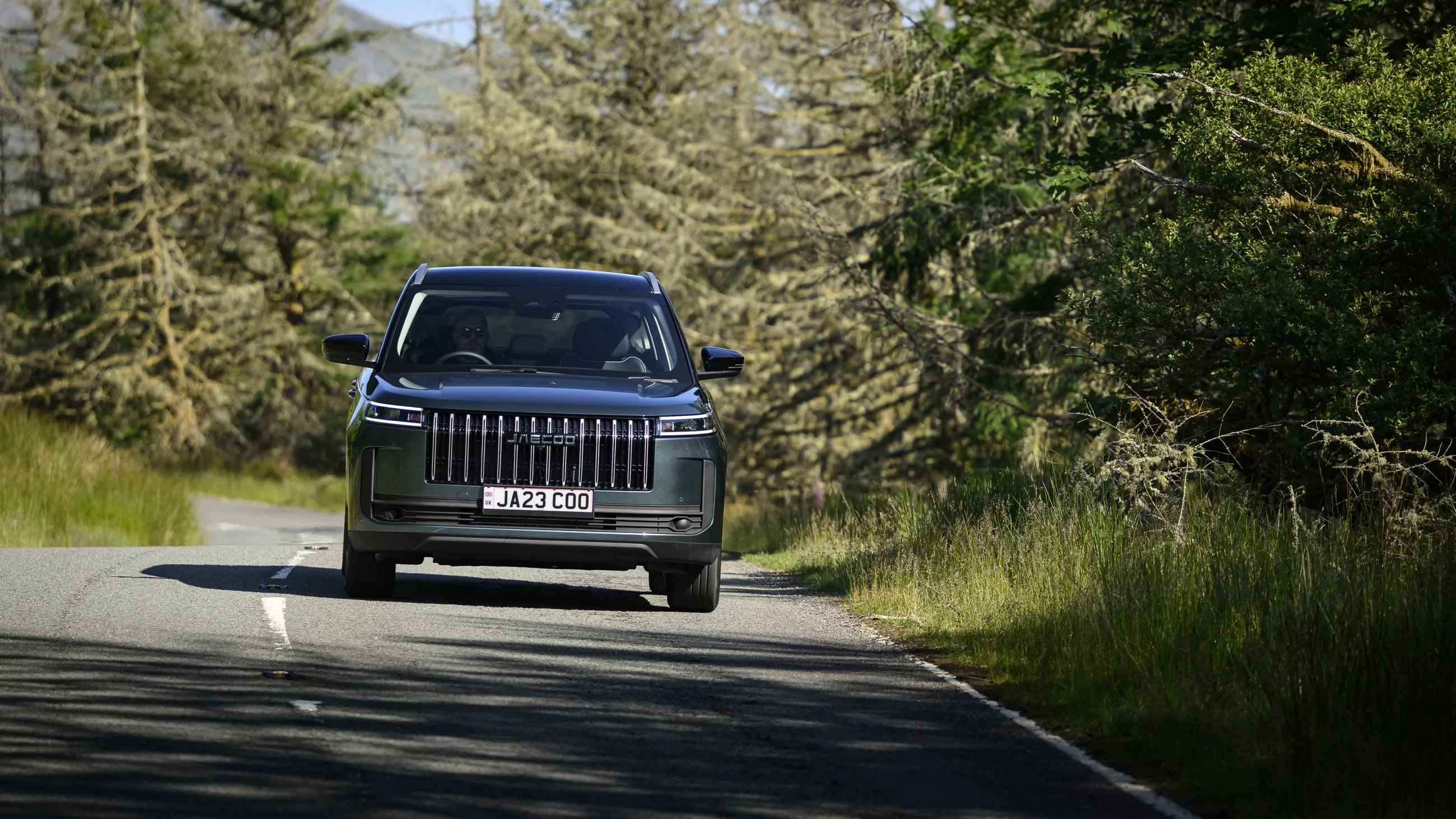 A JAECOO 5 on a forest road