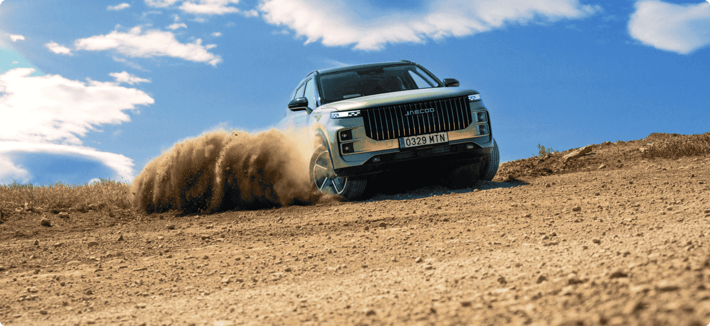 A JAECOO SUV kicking up dust off-road