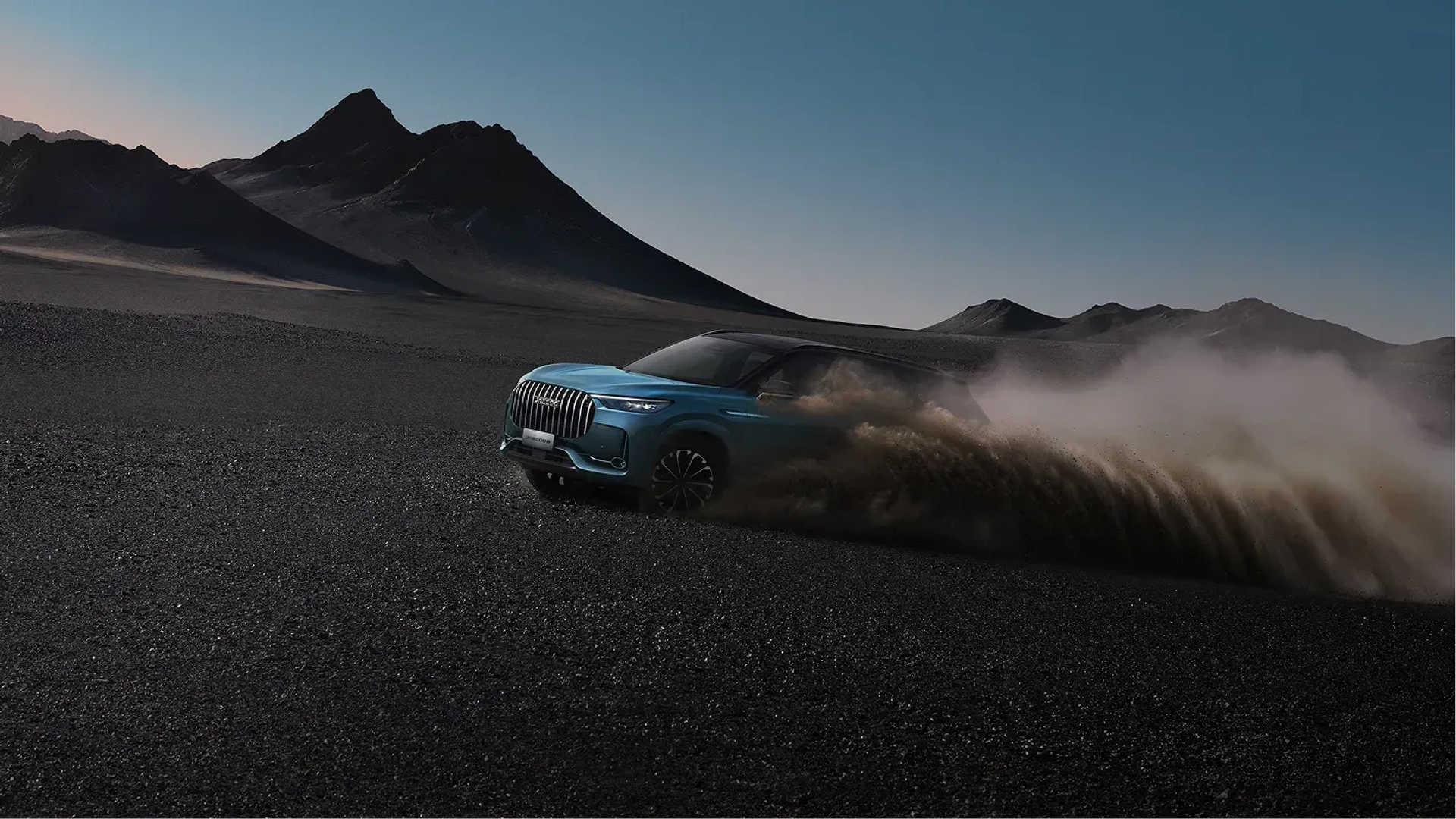 A teal JAECOO SUV kicking up dust across a dark desert plain at dusk