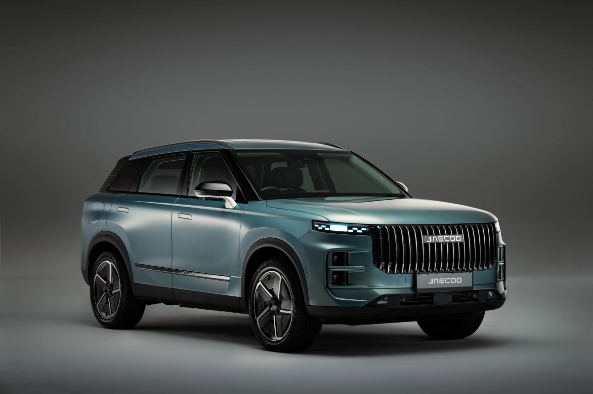 Side view of a green JAECOO SUV in a studio