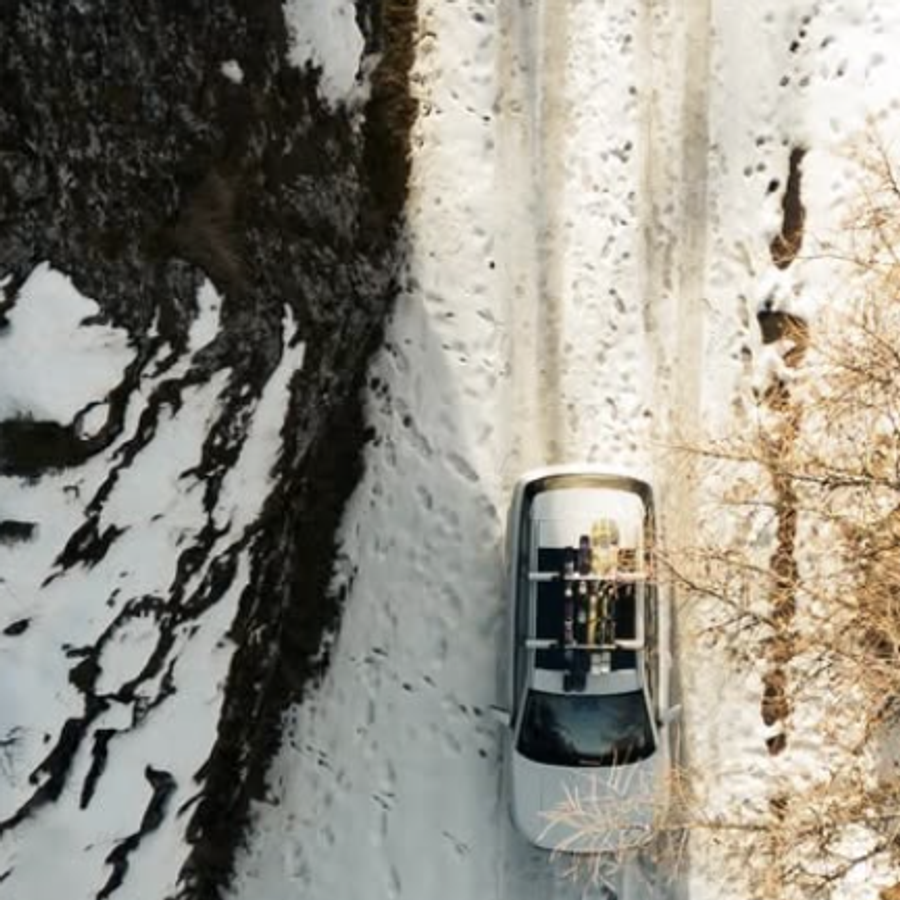 Aerial view of a JAECOO driving a snowy forest track