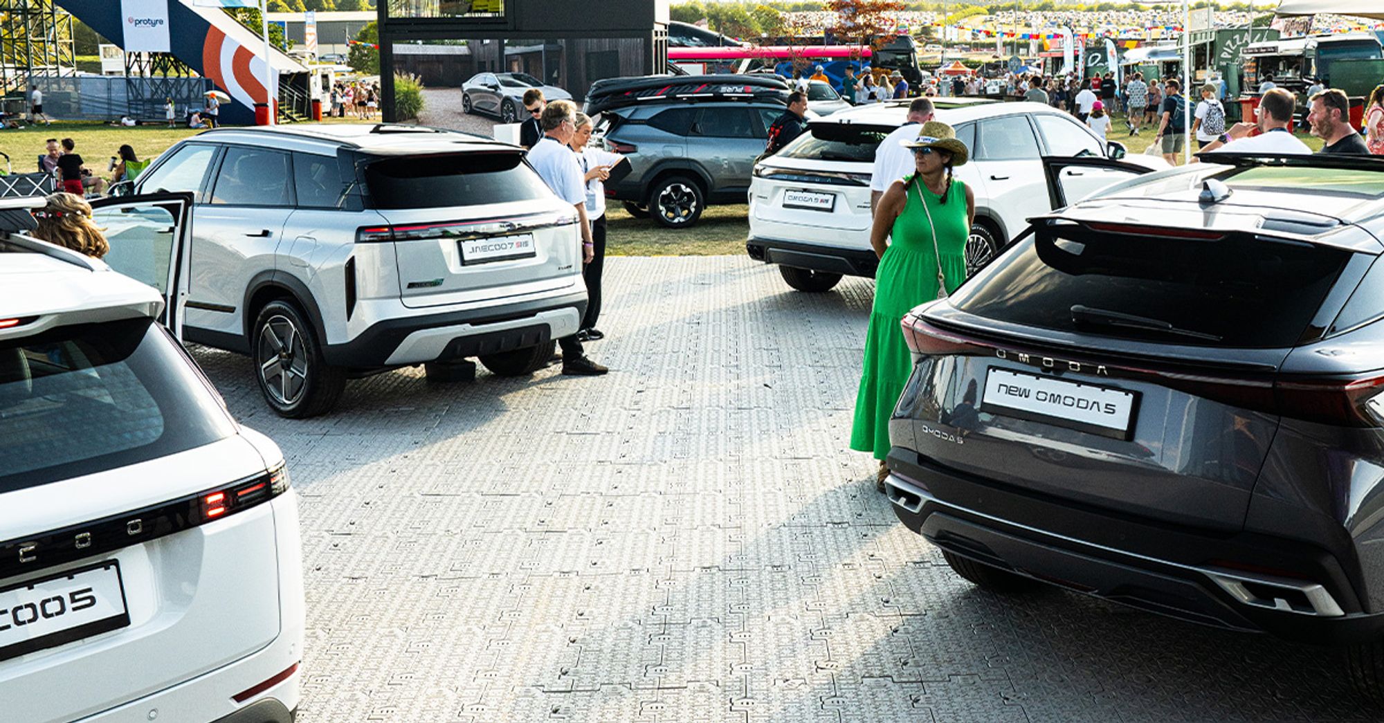 The OMODA&JAECOO stand at CarFest, with visitors exploring the model line-up