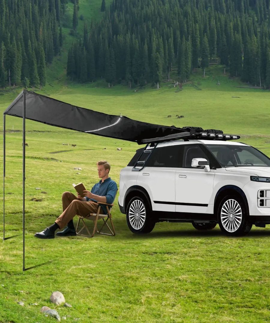 JAECOO fitted with the Adventure Pack roof rack and side awning, pitched on grass