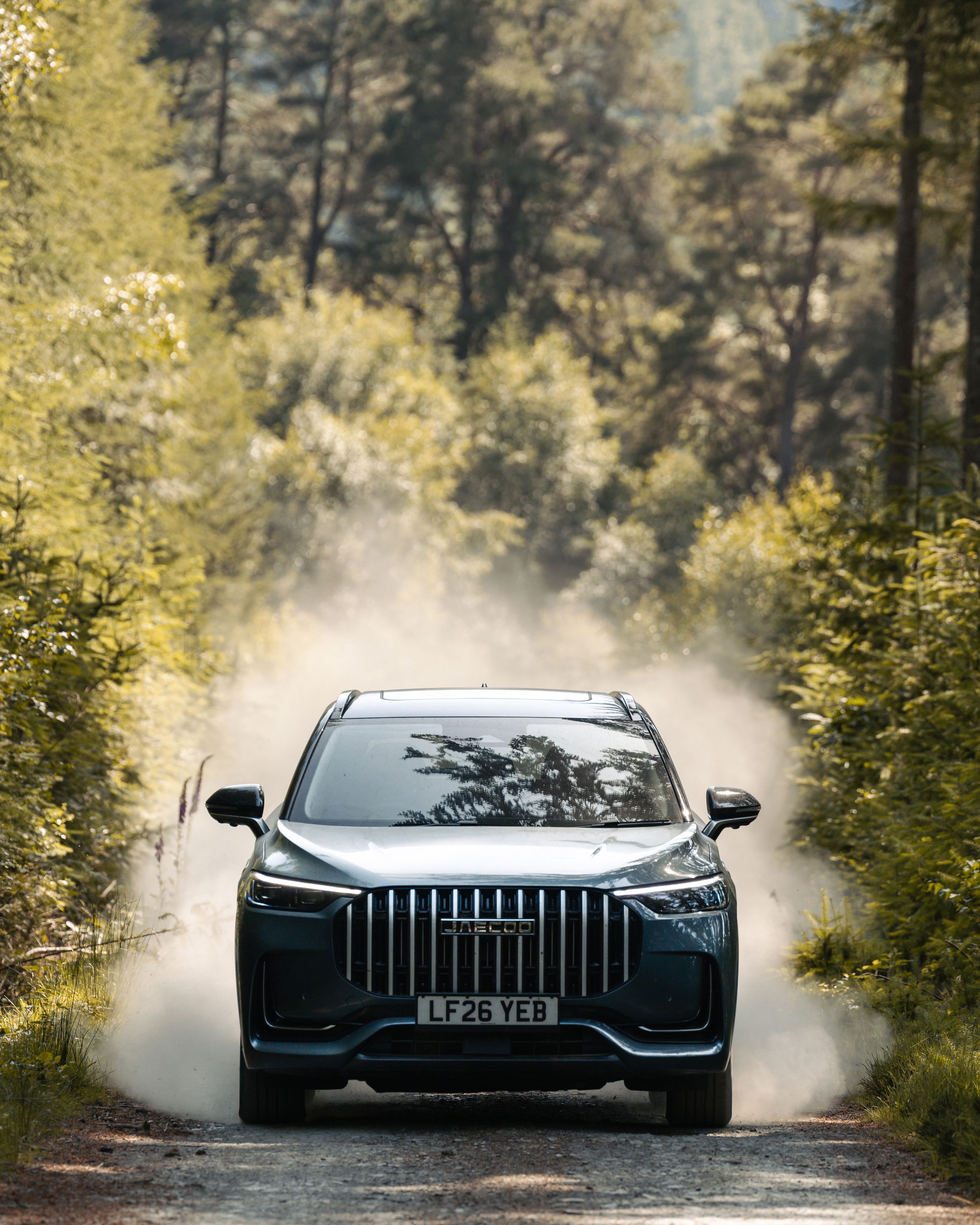 JAECOO 8 on a dusty forest track, front view