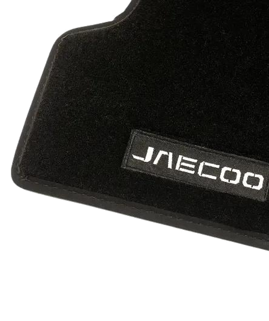Close-up of a genuine JAECOO floormat showing the stitched JAECOO logo badge
