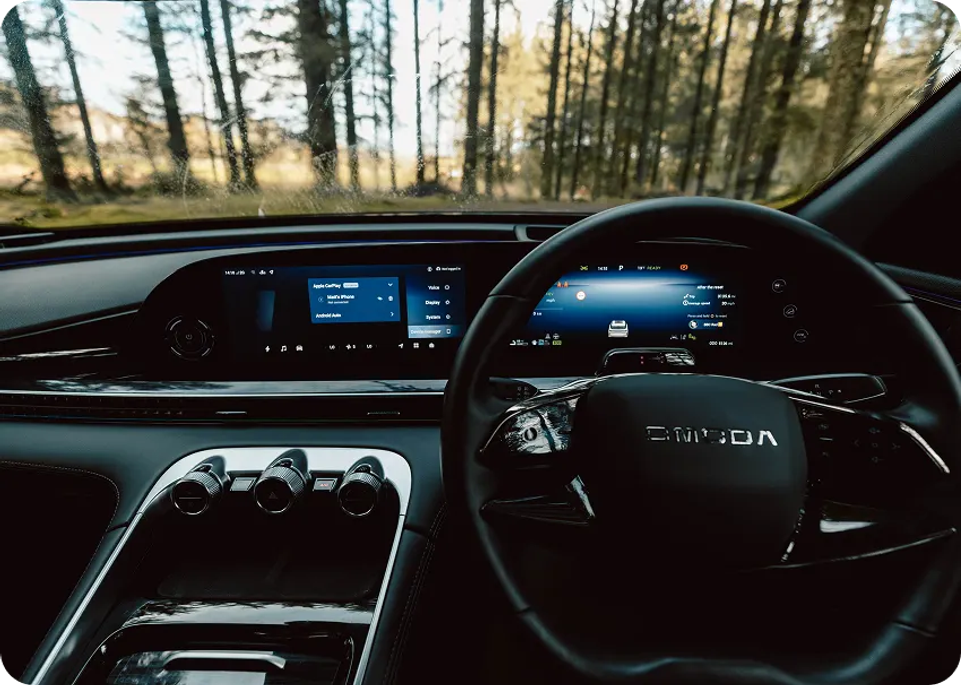Interior OMODA dashboard parked in a misty forest