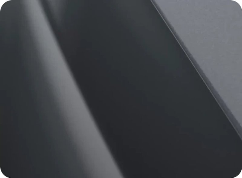 Close-up of a glossy dark OMODA body panel
