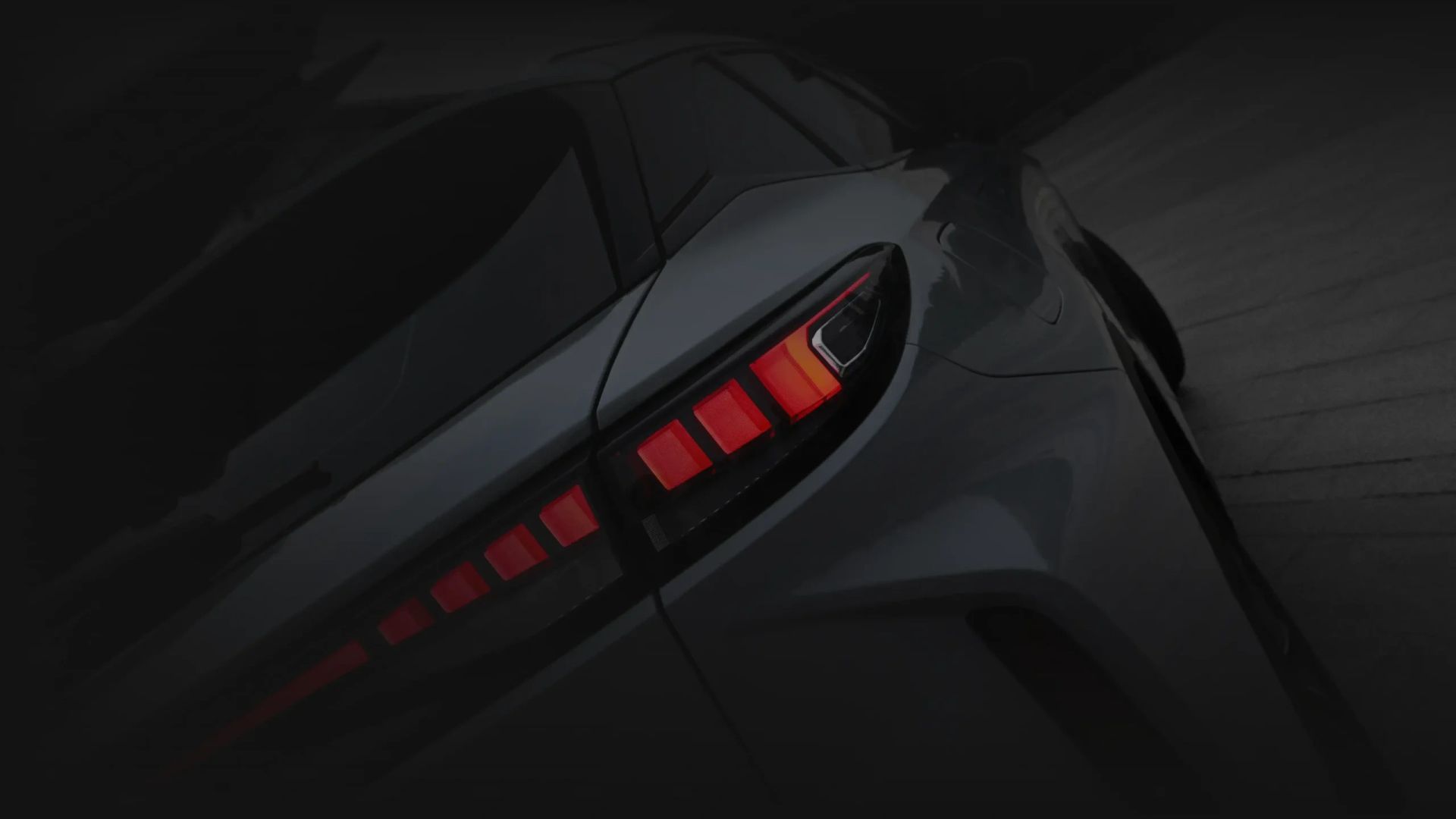 Close-up of a dark OMODA SUV's rear styling and tail light
