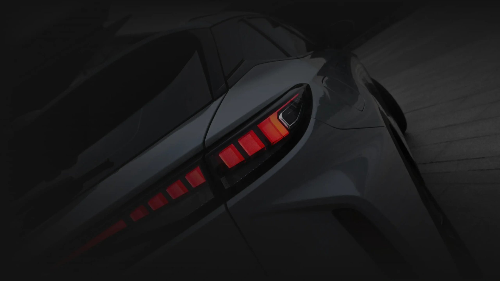 Close-up of a dark OMODA SUV's rear styling and tail light