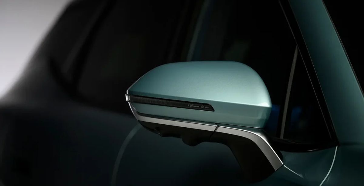 Close-up of an OMODA 7 wing mirror with indicator in green-grey paint