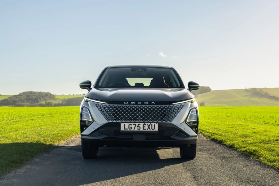 OMODA 5 parked head-on on a country road beside green fields