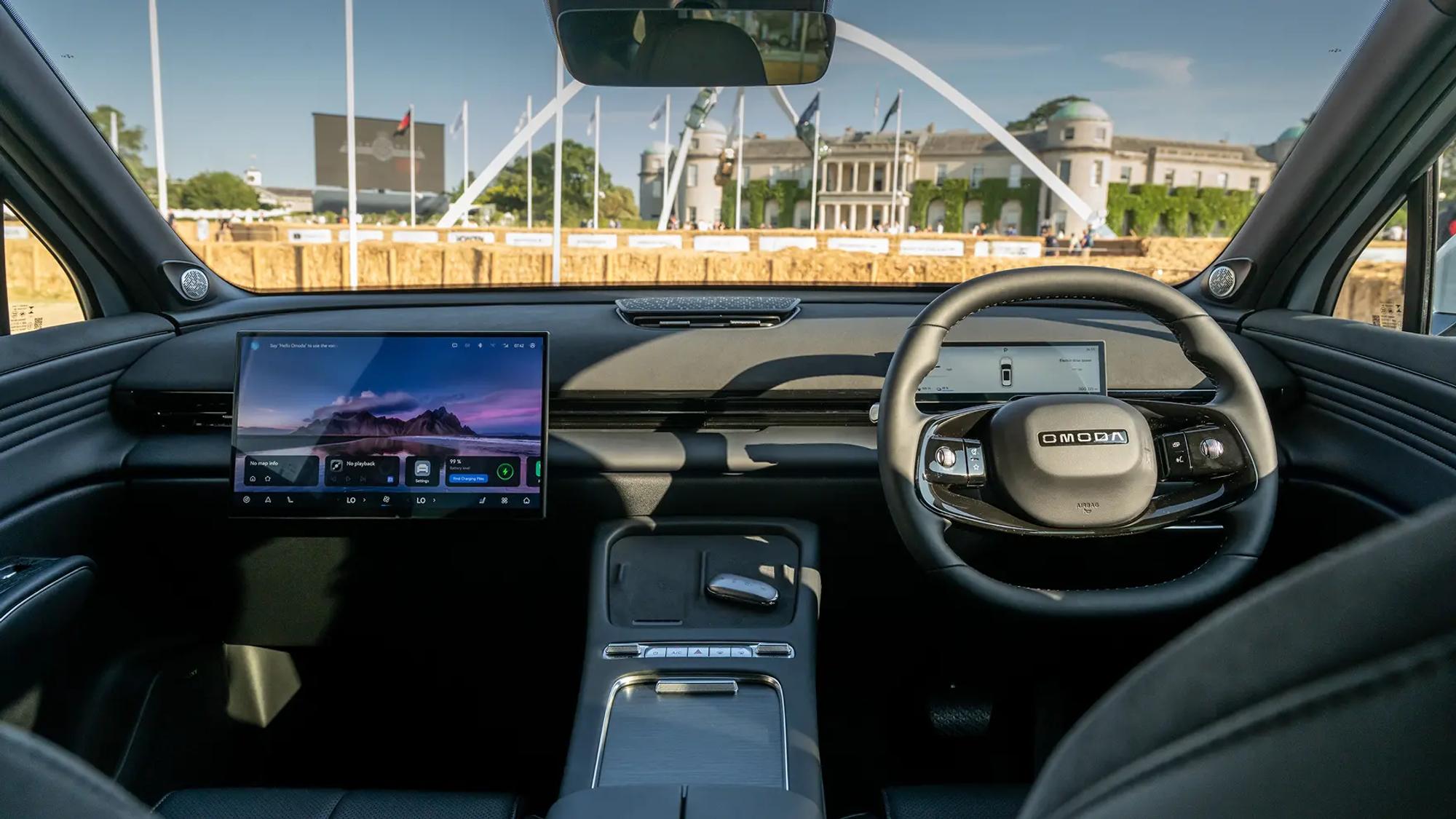Interior of the Omoda 9 showing the passenger and driver seat and the features of the dashboard