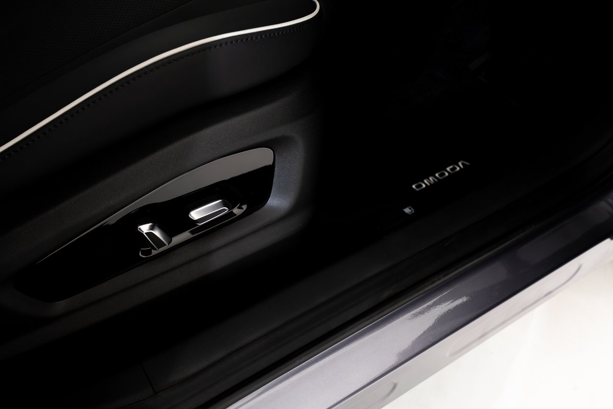 Illuminated OMODA logo on the door sill of the OMODA 5