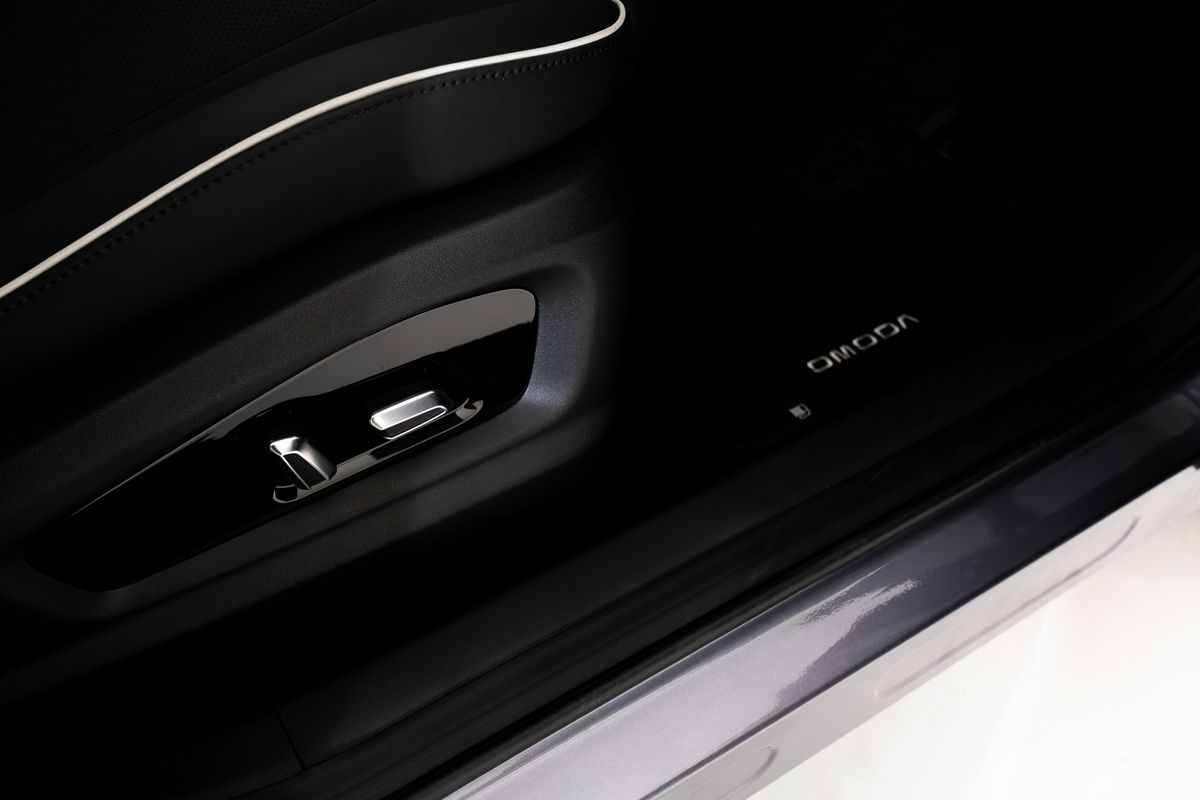 Illuminated OMODA logo on the door sill of the OMODA 5
