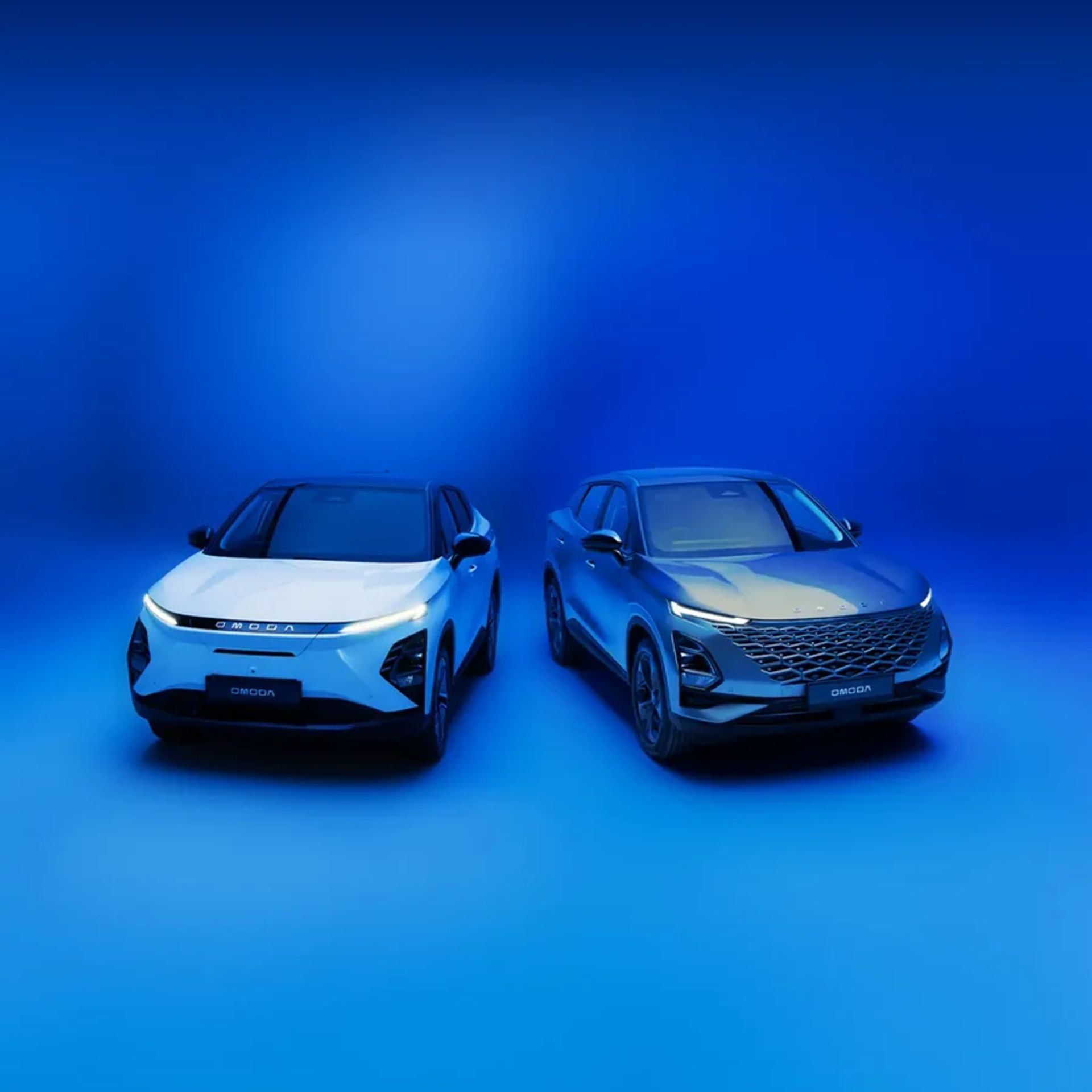 Two OMODA SUVs posed together on a bold blue studio backdrop