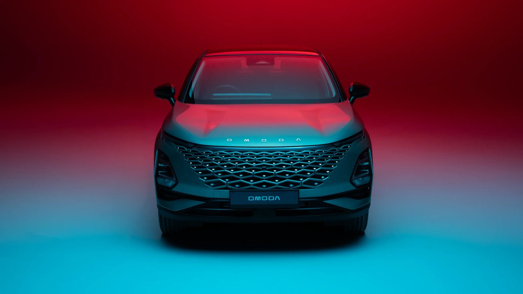 OMODA 5 front view in red and teal studio lighting