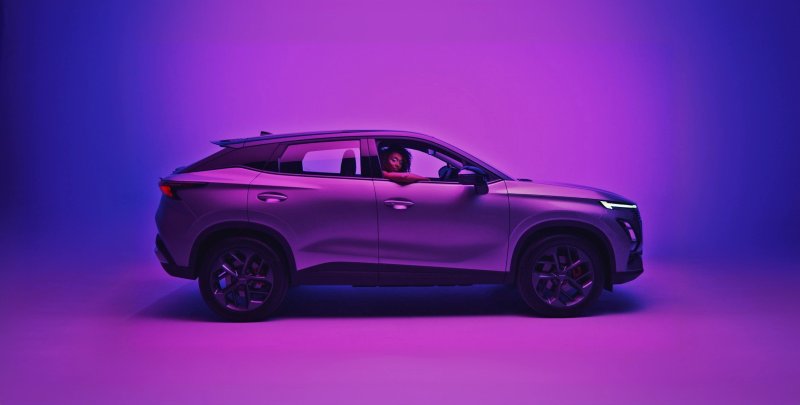 A purple OMODA SUV in a studio lighting setup