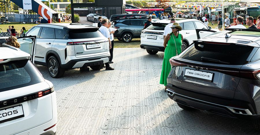 The OMODA&JAECOO stand at CarFest, with visitors exploring the model line-up