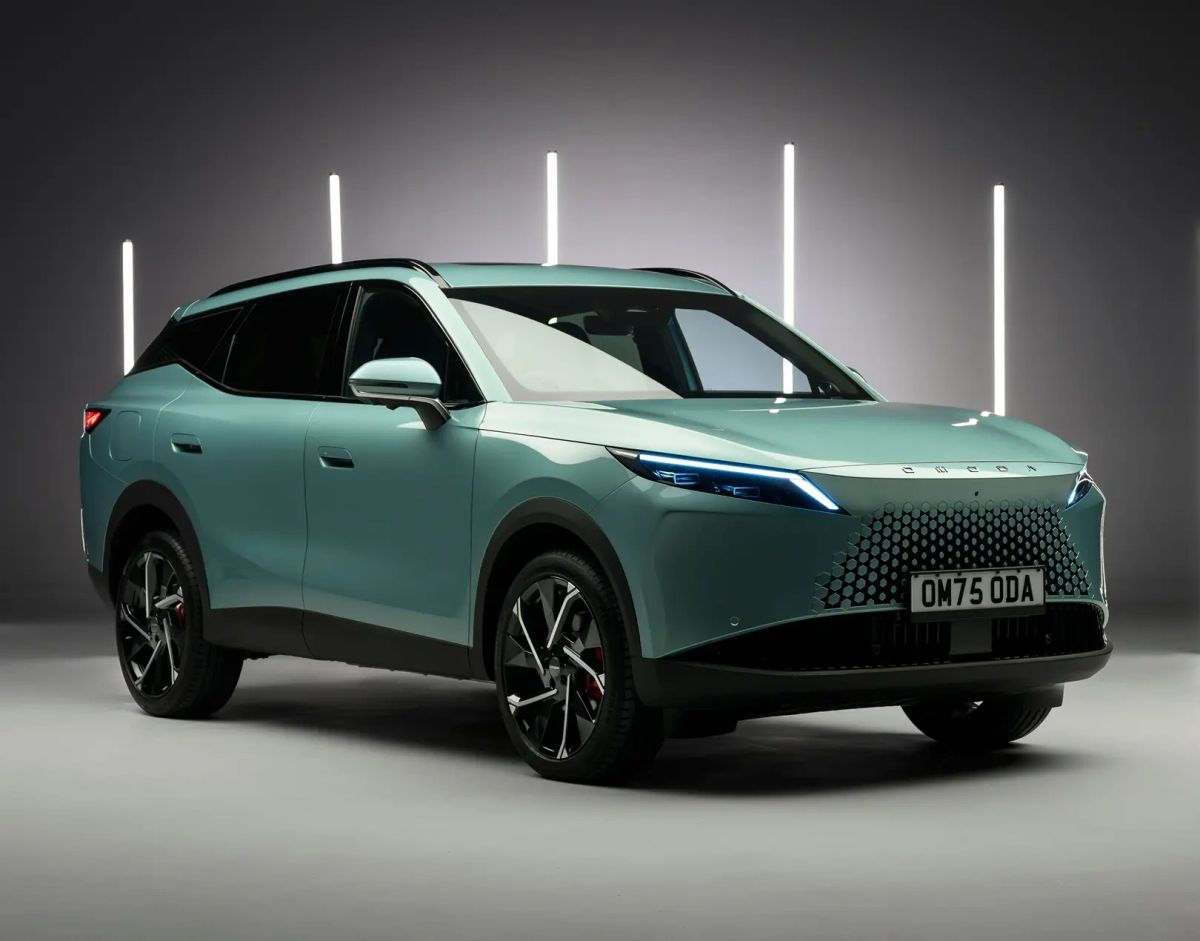 Side view of a green OMODA SUV in a studio