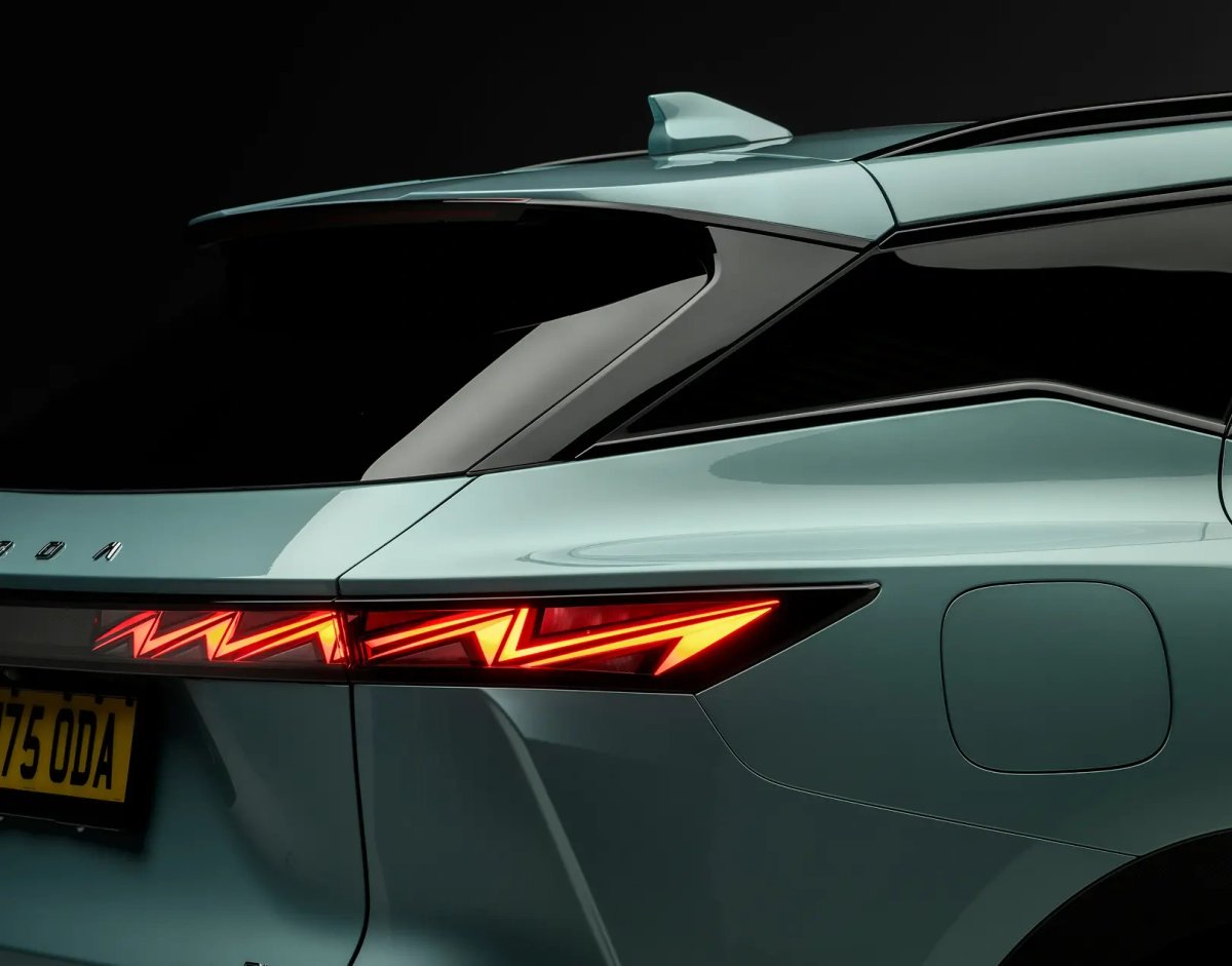 Close-up of the rear tail-light of a green OMODA SUV