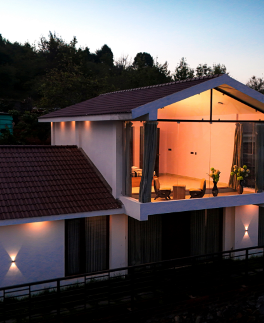 A modern glass-walled retreat nestled among the misty hills of Kodaikanal.