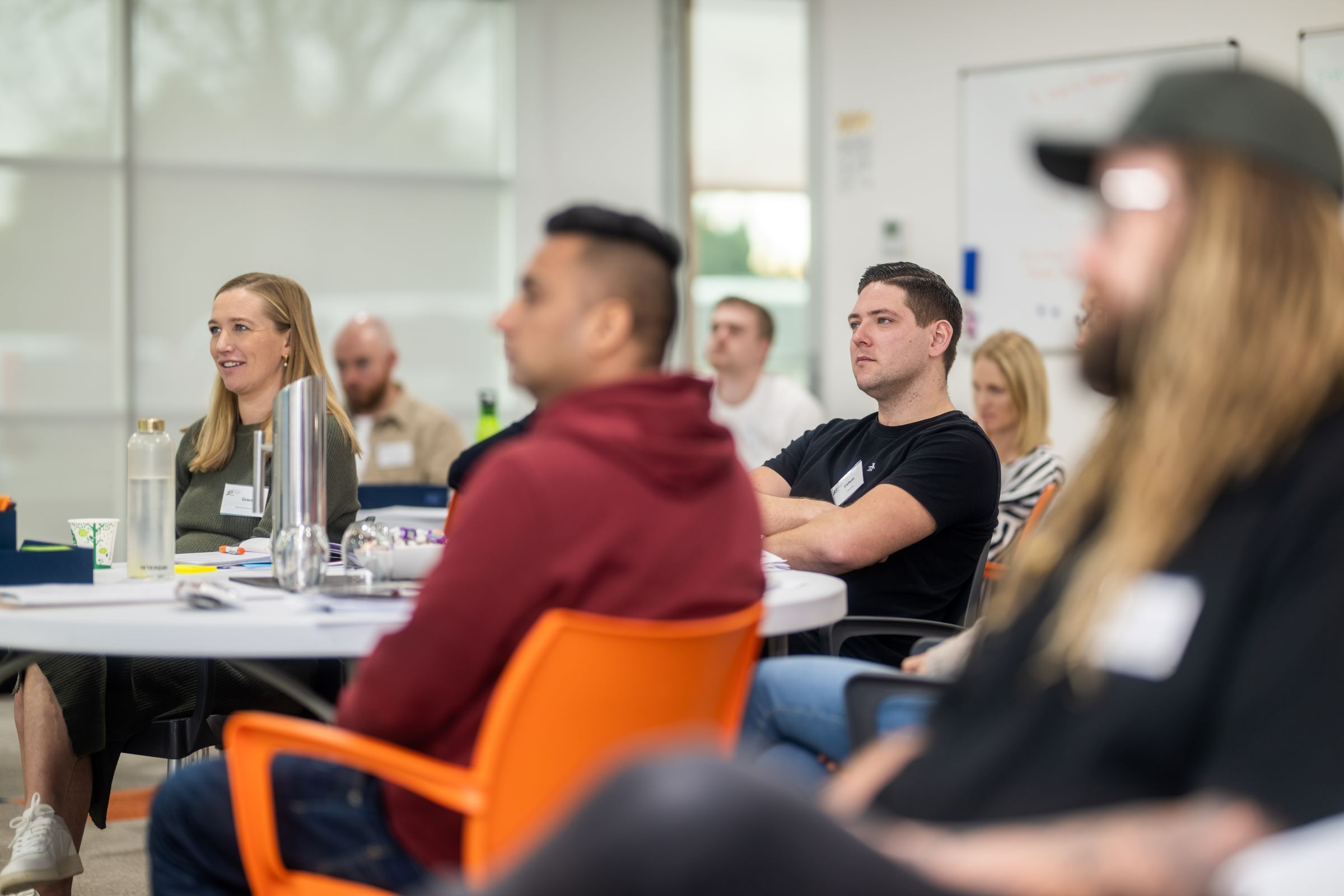 Smiling woman attending an NZIM Team Leader course