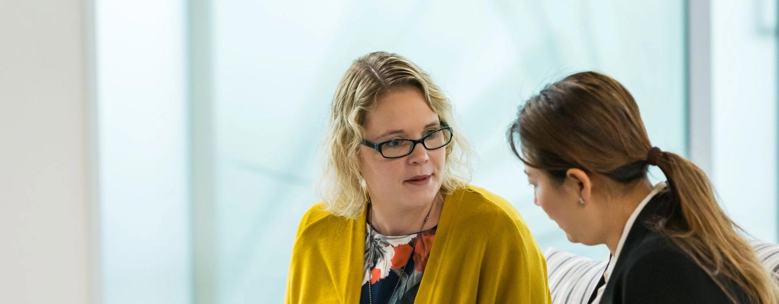 Two women discussion ideas NZIM course