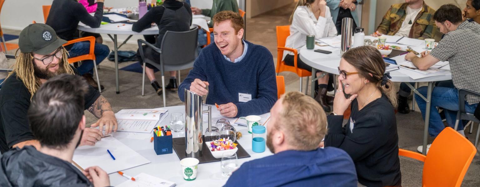 Group of young leaders laughing and discussing strategy 