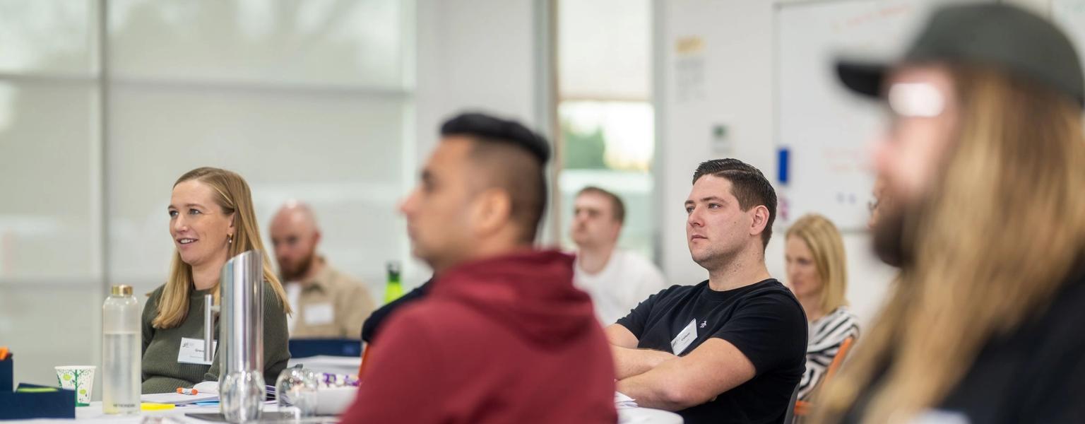 Smiling woman attending an NZIM Team Leader course