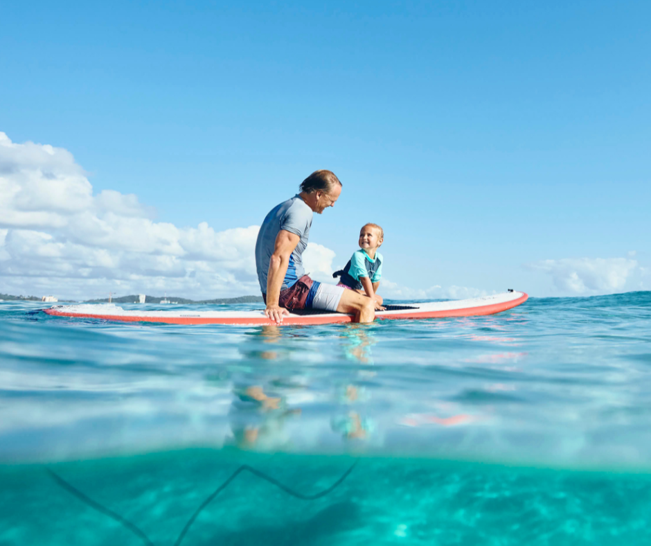 Father and son on a surfboard in Gold Coast