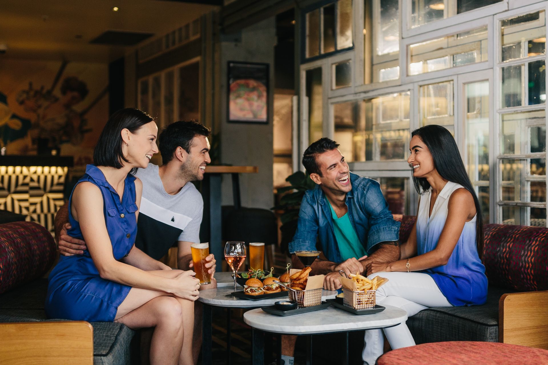 friends-eating-at-restaurant-laughing
