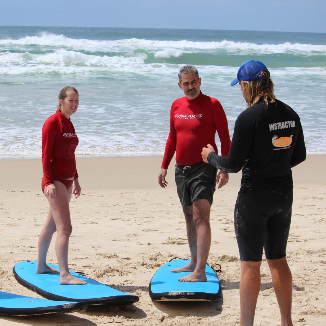 Never too late to start learing to surf. Adults getting surf instructions.