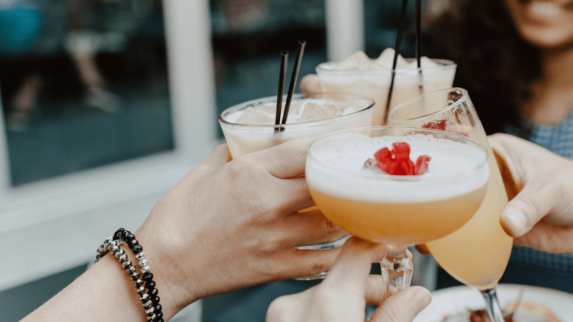 friends-clinking-cocktail-glasses