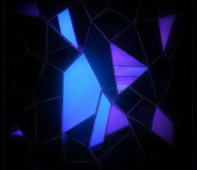 Glowing blue and purple stained-glass shards on a dark field, forming a hidden figure.