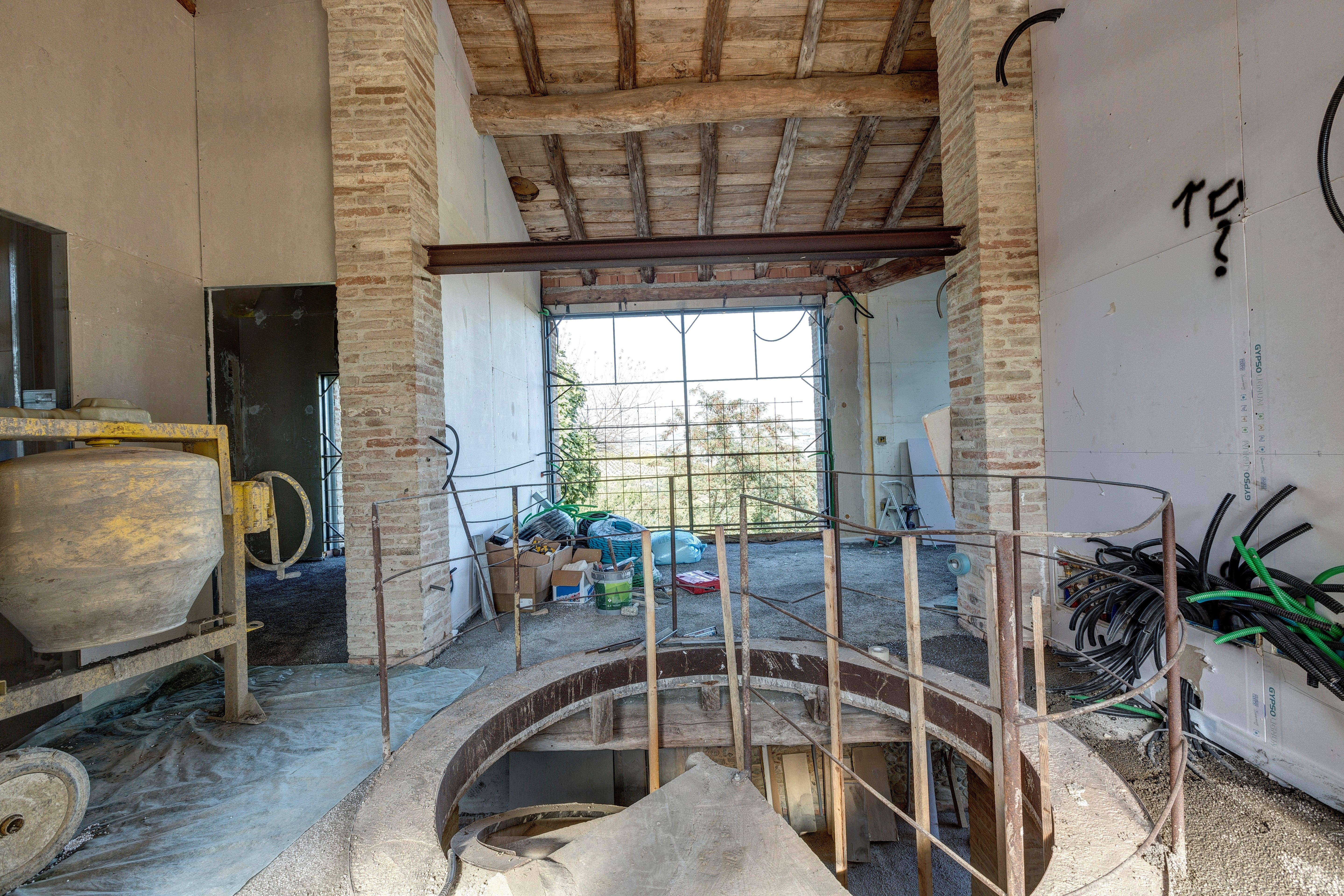 The stairwell opening upstairs, the big window beyond