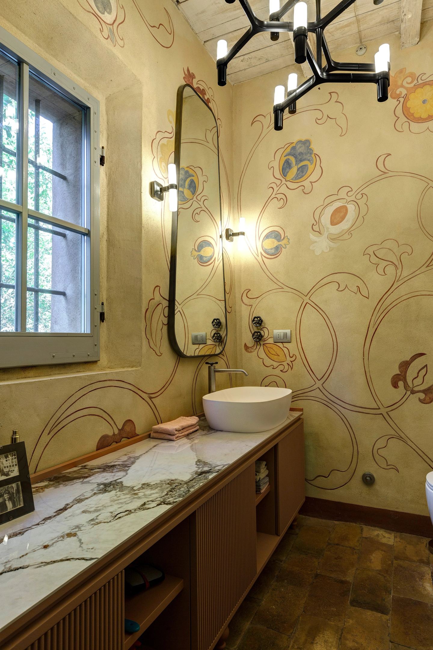 The cabinet, the tall mirror and the painted wall