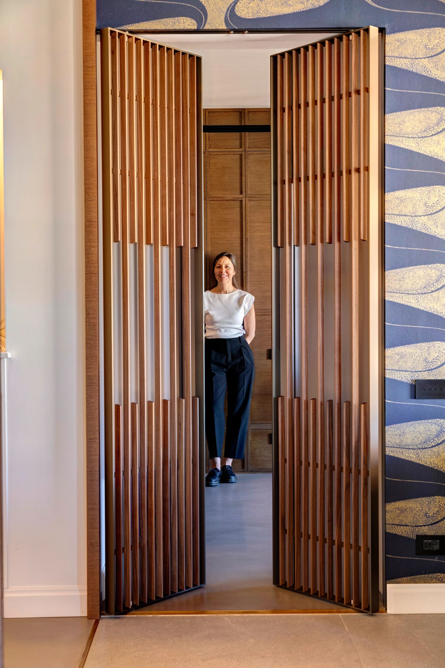 Deniz Onel standing in the open slatted doorway