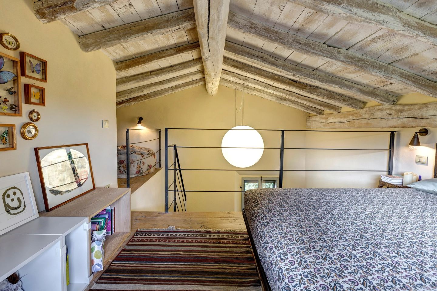 The mezzanine and its rail, the moon pendant hanging in the void