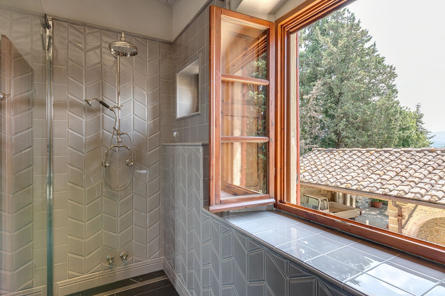The shower, the window left open on the roofs