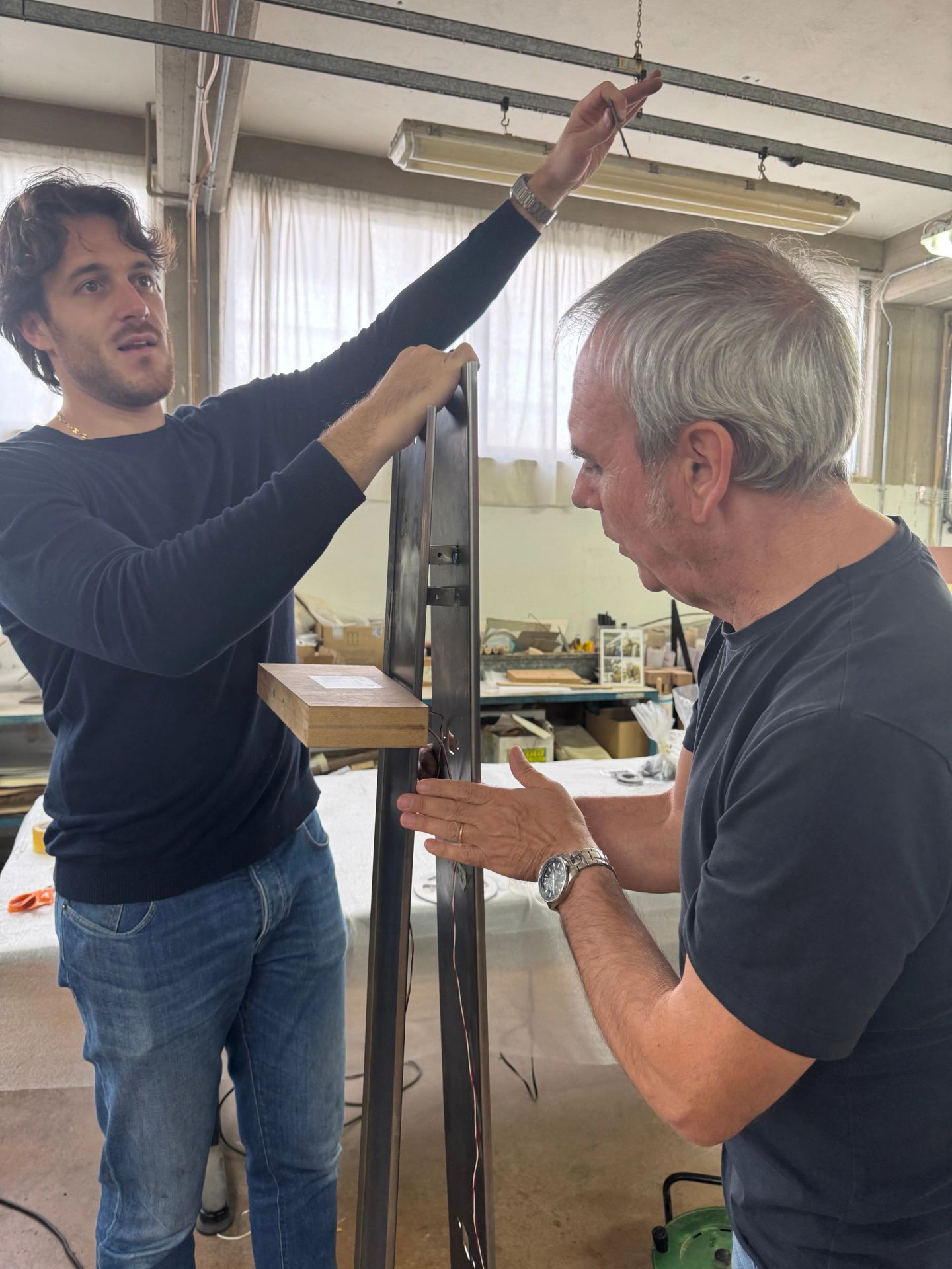 Matteo Pieri of Borzalino and a colleague checking an upright of the library