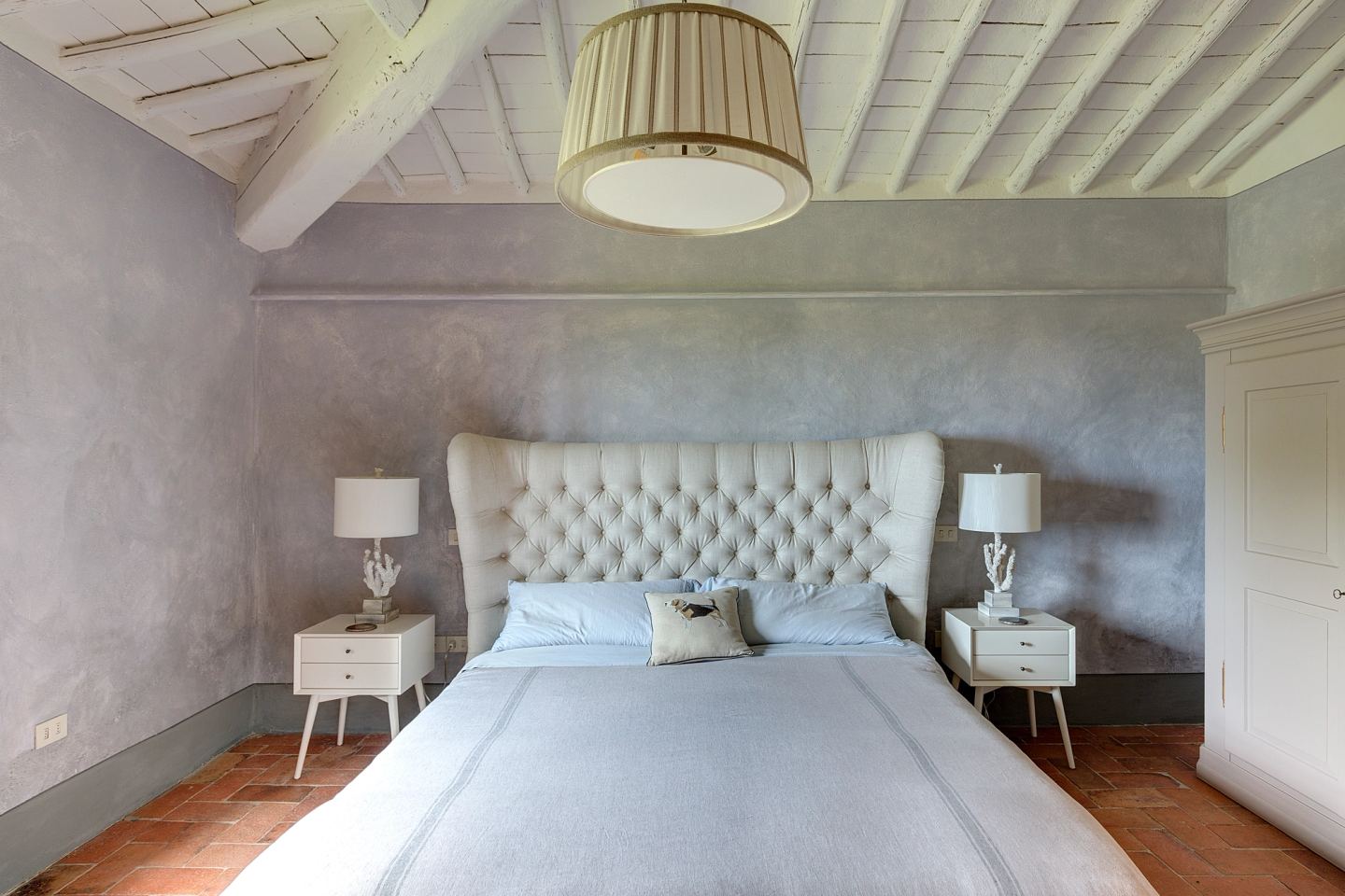 The buttoned headboard filling the wall