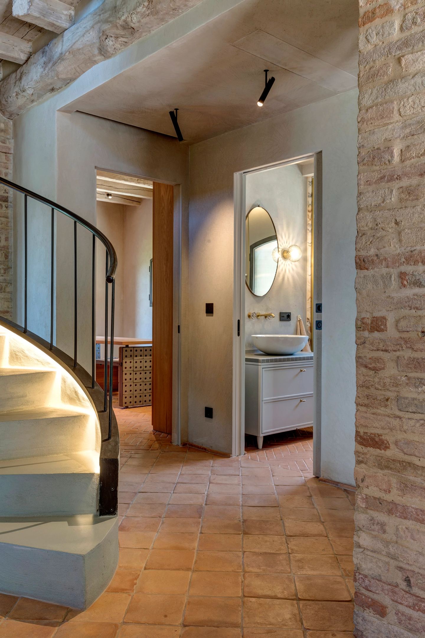 The corridor toward the halfbath, the stair at the left