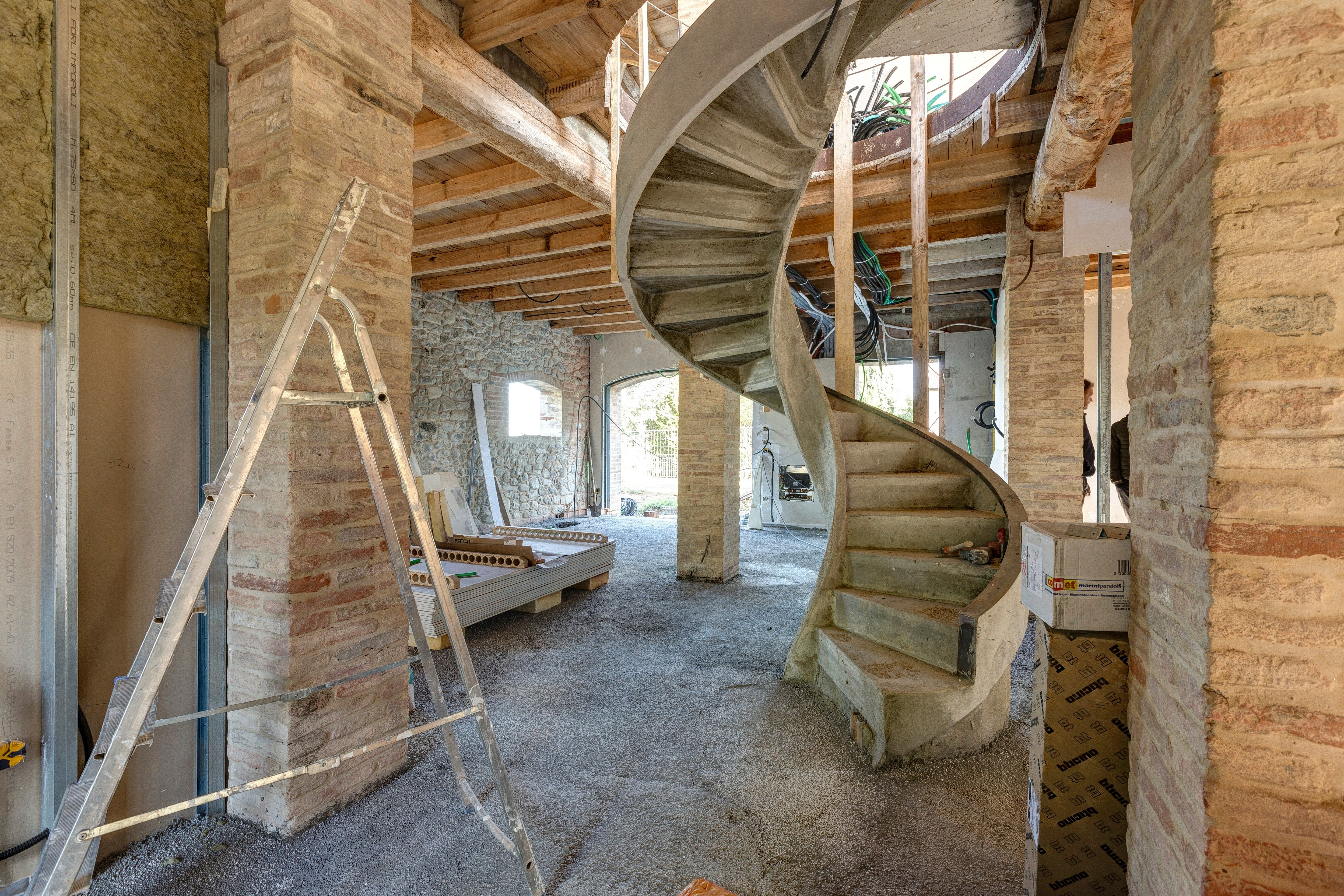 The spiral stair standing in raw concrete