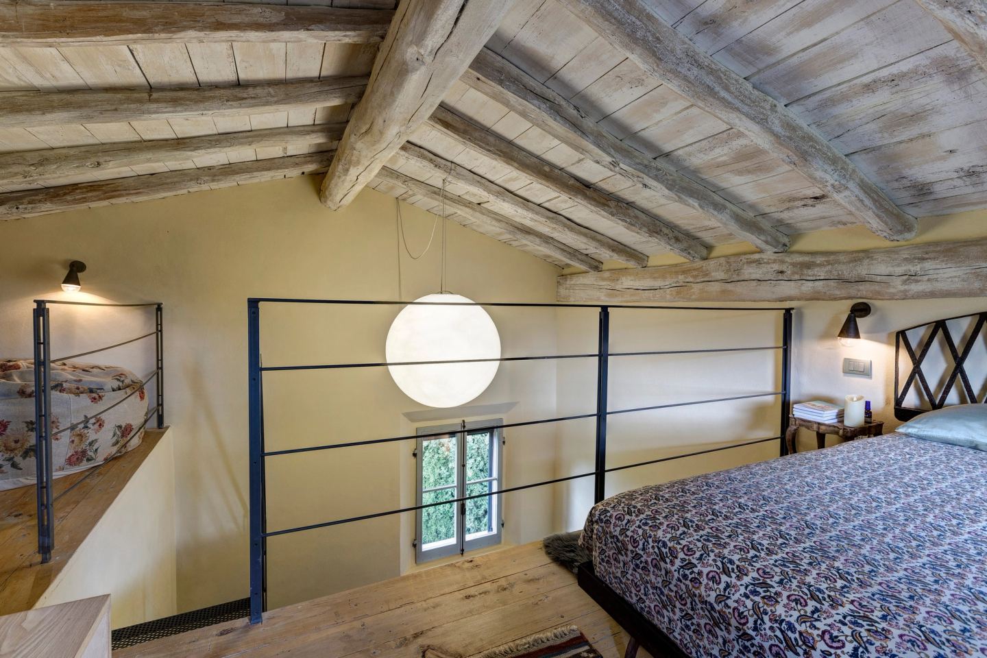 The moon pendant between the rail and the bed