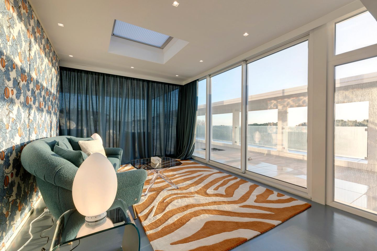 The glazed wall onto the terrace, curtains open
