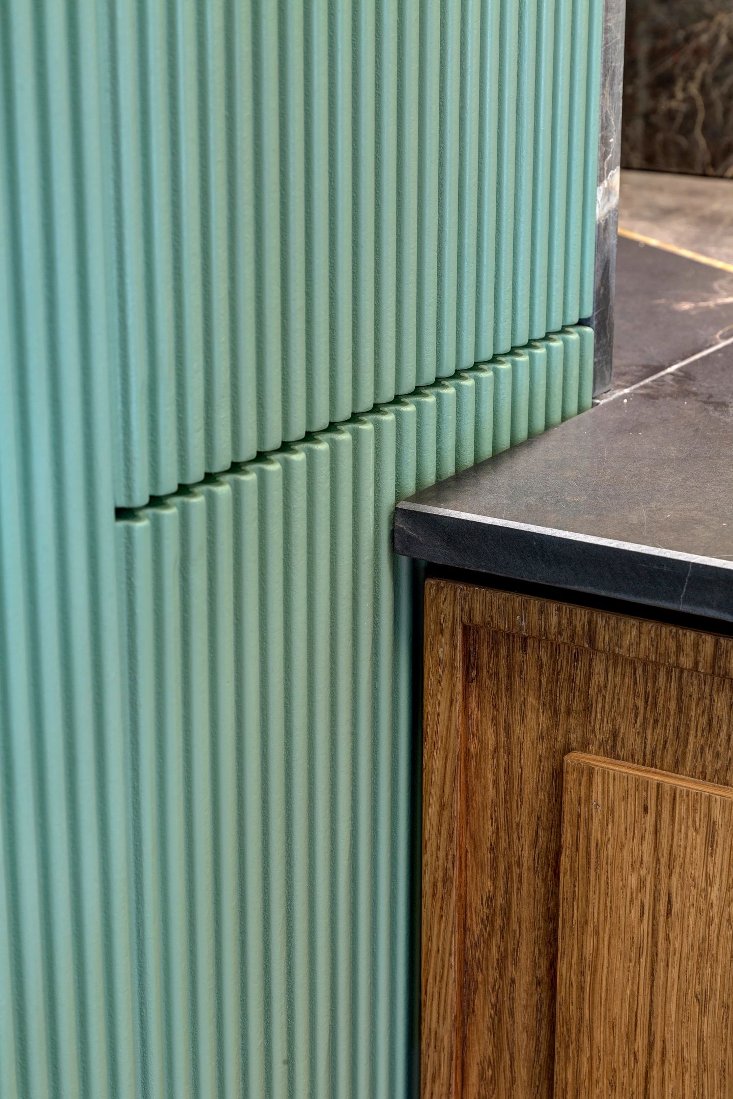 Fluted green against oak and dark stone