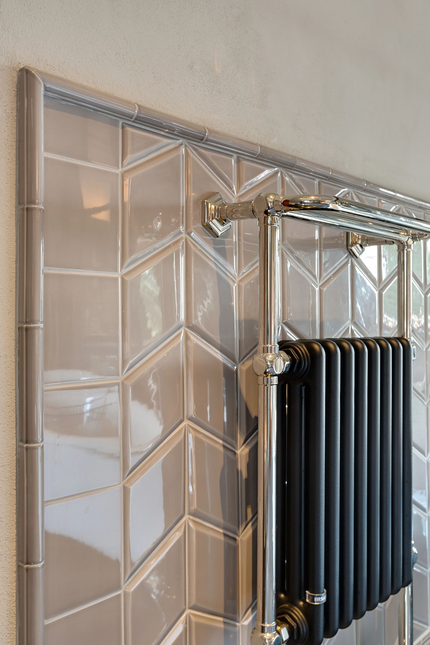 Tiles laid in chevron beside the cast-iron radiator