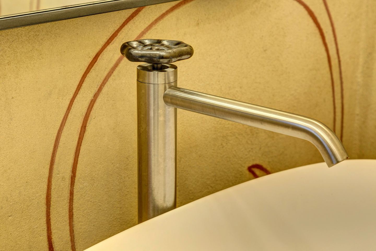 The tap over the basin, the painted scrolls behind