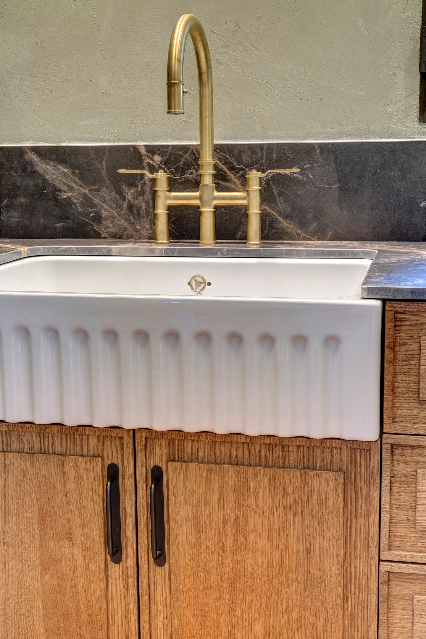 The fluted sink below the brass bridge tap