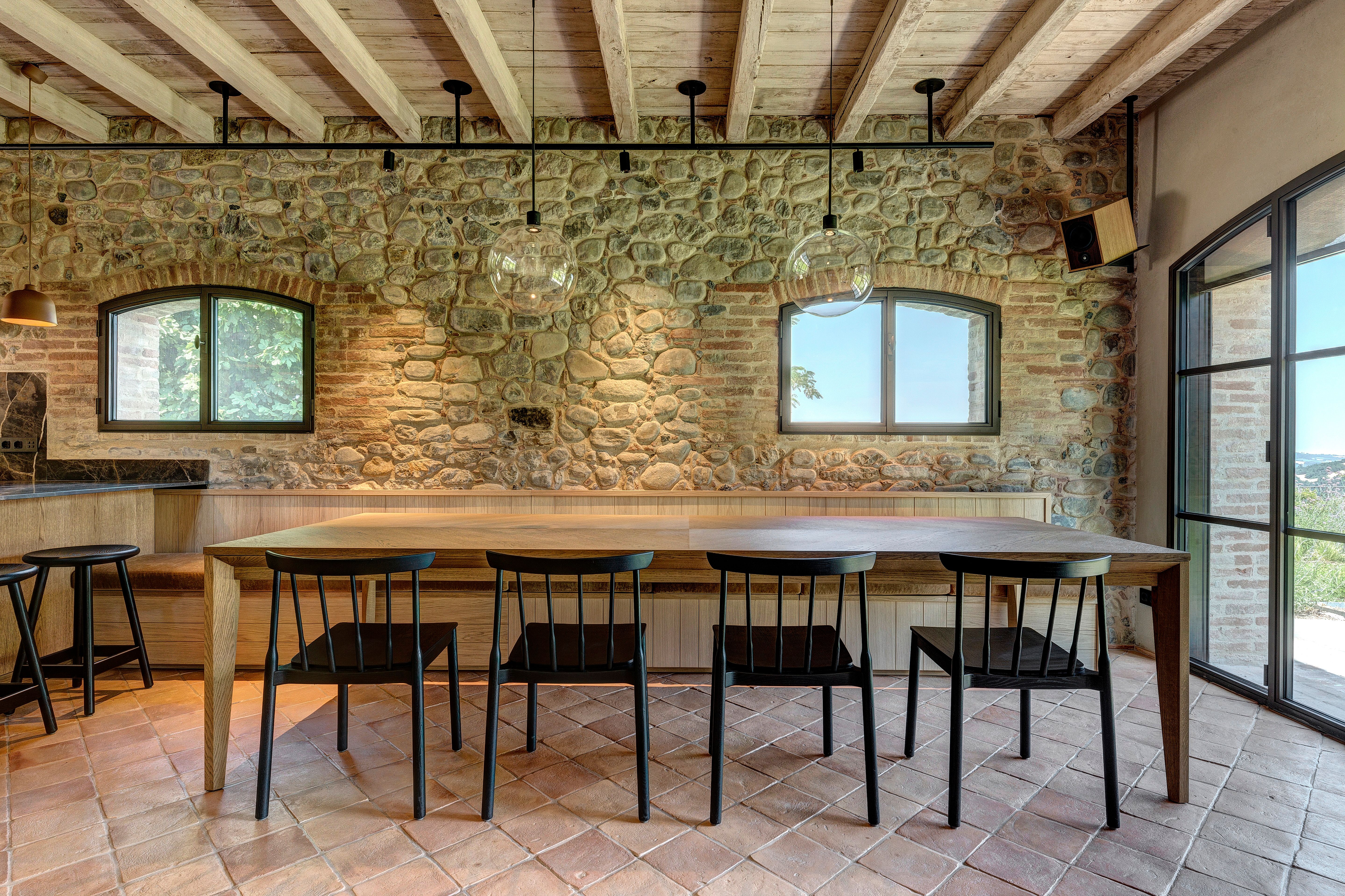 The table set for eight against the stone wall